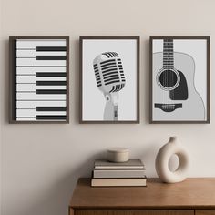 three posters with musical instruments are hanging on the wall next to a vase and book