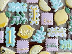 decorated cookies are arranged on a table for a one - year birthday party or baby's first birthday