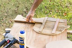 a man is working with wood and glue