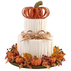 a three tiered cake decorated with pumpkins and leaves