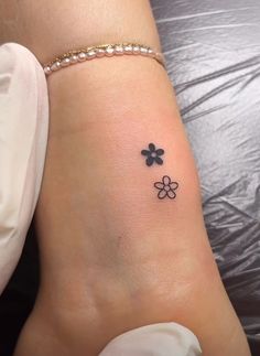 a woman's foot with four clovers tattoo on it