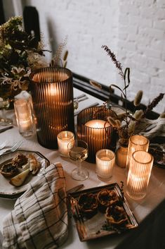 the table is set with candles and plates