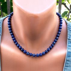 Add a touch of elegance to your ensemble with this exquisite Lapis Lazuli Necklace. Featuring beautiful 8mm Lapis Lazuli beads in varying shades of blue, this stunning necklace exudes timeless beauty and sophistication. Each bead is meticulously strung on durable steel wire and finished with a secure clasp, ensuring both style and durability. Elevate your look with this captivating blue gemstone jewelry that is perfect for any occasion. Necklace length 18 Inches + 2 in Extender Difference in colors ------------------------------ Due to the different settings on monitors and displays, the colors may differ from those you see on your screen. The pictures were taken outside in natural sunlight and there may be a difference in color in room light. ---------------------------------------------- Lapis Lazuli Gemstone Beads Pearl Necklace, Royal Blue Lapis Lazuli Necklaces With Round Beads, Pearl Necklace With Lapis Lazuli Gemstone Beads, Royal Blue Lapis Lazuli Necklace With Round Beads, Lapis Lazuli Round Beaded Necklaces, Lapis Lazuli Necklaces With 8mm Beads, Lapis Lazuli Necklace With 8mm Beads, Necklace With 8mm Round Lapis Lazuli Beads, Formal Lapis Lazuli Necklace With Round Beads