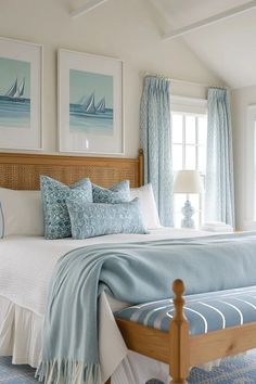 a bed sitting in a bedroom next to two framed pictures on the wall above it