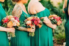 the bridesmaids are wearing green dresses with red and orange flowers in their bouquets