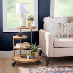 a living room filled with furniture and a white chair next to a table topped with potted plants