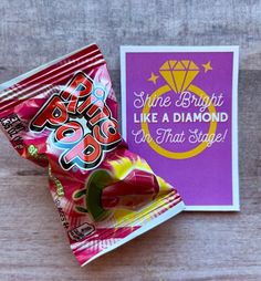 a candy bar wrapper next to a purple card with the words, shine bright like a diamond on it