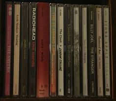 a collection of cd's are sitting on a shelf