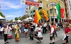 a group of people walking down a street holding flags