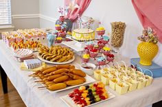 a table filled with lots of food and desserts