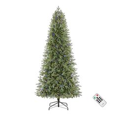 an artificial christmas tree with lights and remote control on the stand, next to it's base