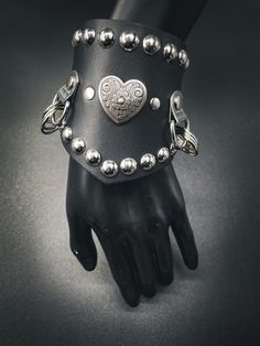 This "Savage Vixen" cuff is subtle but eye catching! Get this flawless design today! You will not regret it. ✨ Adjustable 8" to 9" inches. ✨ 3-1/2 inches at widest point ✨ Steel snaps ✨ Sturdy 7-8 oz leather Edgy Black Cuff Bracelet With Rivets, Silver Rivets Wristband For Concert, Rocker Leather Bracelet With Rivets For Festivals, Rocker Style Leather Bracelet With Rivets For Concert, Rock Style Wristband With Rivets For Concerts, Punk Style Adjustable Cuff Bracelet With Rivets, Punk Adjustable Cuff Bracelet With Rivets, Adjustable Punk Cuff Bracelet With Rivets, Edgy Bracelets With Rivets For Festival