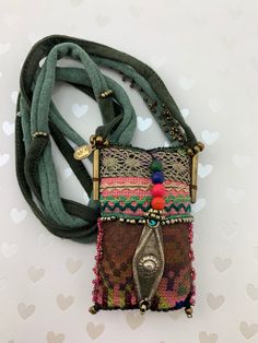 a multicolored purse with metal clasps and beads on it's side