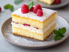 a piece of cake on a plate with raspberries