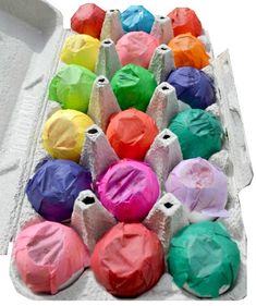 an egg carton filled with lots of colored eggs