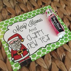 a merry christmas and happy new year card with a candy bar in the shape of santa claus