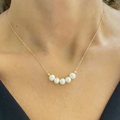 - Beaded Pearl Necklace is made with high quality 14K real solid gold. - Dainty, delicate, elegant and 14K solid gold pearl necklace is a perfect example of a minimalist women's ring. - Beaded necklace is decorated with five Cultured Freshwater Pearls. Pearl size is 6MM and their shape is oval. - You receive beaded pearl jewelry in a beautiful and free gift box - Free shipping (Arrive within 5 business days to the USA and Canada ( 2 day for production + 3 days for shipment)) - 14K Solid Gold Dai Dainty Round Bead Necklaces For Anniversary, Dainty Round Bead Necklace For Anniversary, Akoya Pearl Necklaces With Round Beads For Gifts, Single Strand Akoya Pearl Beaded Necklace As Gift, Akoya Pearl Beaded Necklace As Gift, Akoya Pearl Beaded Necklace For Gift, Elegant Tiny Beads Jewelry For Anniversary, Elegant Jewelry With Tiny Beads For Anniversary, Pearl White Beaded Necklaces For Anniversary