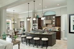 an image of a kitchen and living room in the same house, with pictures on it