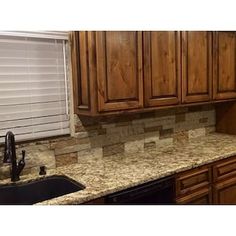 a kitchen with wooden cabinets and granite counter tops