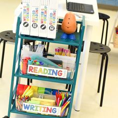 there is a book shelf with many books on it and a laptop in the background