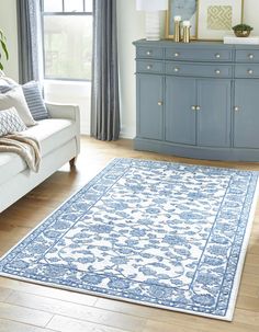 a blue and white rug in a living room