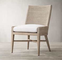 an upholstered chair with a white cushion