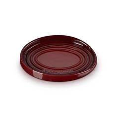 a red plate sitting on top of a white table