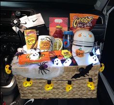 a car trunk filled with halloween treats and candy bar decorations, including ghost candies