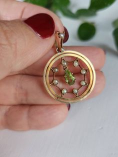 A sweet victorian circular pendant made in 9ct gold. The pendant has an intricate design (looks like a spider web??) with a pear shaped genuine peridot dangling in the middle. The diameter of the pendant is 2.2cm. Total weight is approximately 3.14g.  In great antique condition with no visible flaws. There is some patina noted on the gold. It is stamped 9c on the back of the bail, indicating possible British origin. Some dark spots in the photos are just reflections of surroundings.  This sweet Ornate Oval Pearl Pendant Jewelry, Victorian Pearl Pendant Jewelry, Victorian Style Round Pearl Pendant Jewelry, Victorian Jewelry With Pearl Pendant, Victorian Style Round Pearl Pendant, Antique Medallion Pearl Pendant Jewelry, Antique Oval Pearl Pendant Jewelry, Ornate Round Necklace With Pearl Pendant, Ornate Round Necklaces With Pearl Pendant