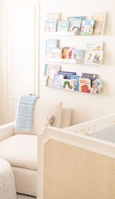 a baby's room with books on the wall