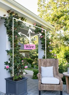 a chair sitting on top of a patio next to a planter filled with flowers