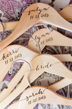 wooden wedding dress hangers with names and date on them for the bride and groom