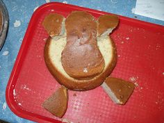 a cake shaped like a cow on top of a red tray