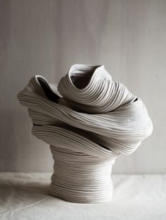 a white vase sitting on top of a table