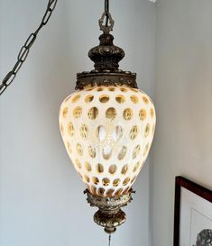 an ornate light fixture hanging from the ceiling