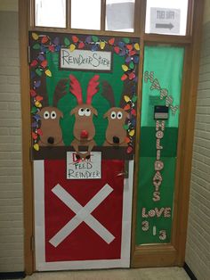 a door decorated to look like a farm scene with reindeers and a red barn