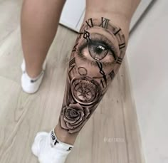 a woman's leg with an eye and clock on it