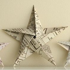 three folded origami stars on a shelf with text overlay that reads 5 pointed origam star tutor