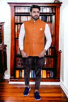 Add a touch of timeless elegance to your wardrobe with our exquisite Jute Orange Nehru Jacket. Handcrafted with precision and care, this jacket is a perfect blend of traditional style and modern sophistication. Crafted from high-quality jute fabric, this Nehru jacket offers a unique texture that sets it apart from conventional options. The natural earthy tones of jute are complemented by intricate detailing, making it a versatile piece that can be dressed up or down for various occasions. The minimalist yet captivating design features a mandarin collar that exudes refined class. The front placket with carefully selected buttons adds an element of charm and functionality. Whether you're attending a formal event, a cultural celebration, or simply want to elevate your everyday style, this Jut Traditional Fitted Nehru Jacket For Fall, Traditional Semi-formal Winter Outerwear, Festive Nehru Jacket With Stand Collar For Fall, Festive Nehru Jacket For Workwear, Traditional Semi-formal Nehru Jacket For Fall, Traditional Semi-formal Fall Nehru Jacket, Traditional Fall Semi-formal Nehru Jacket, Brown Fitted Nehru Jacket For Winter, Traditional Fitted Vest For Fall