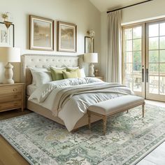 a large bed sitting inside of a bedroom on top of a rug