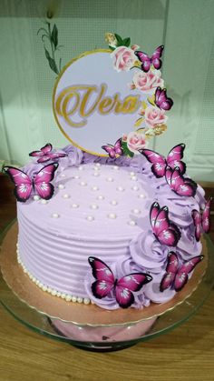 there is a cake with butterflies on it and the name vera written in gold lettering