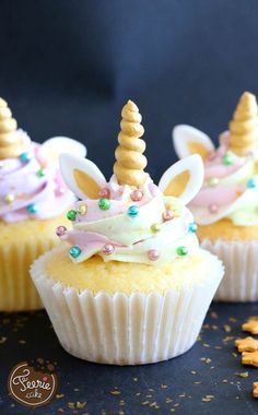 cupcakes decorated with unicorn ears and bows