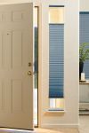 an open door in a room with blue roller shades