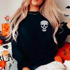 "Skull Sweatshirt, Glitter Skull Sweatshirt, Skull Sweater, Spooky Sweatshirt, Halloween Sweatshirt, Skeleton Sweatshirt, Skull Shirt, Gothic Our spooky Halloween skull sweatshirt makes the perfect addition to your wardrobe this Halloween. The bats are made of a high quality black or silver glitter that won't fall off or leave glitter anywhere, not even after washing. If you have any questions feel free to reach out and I am happy to help. PLEASE NOTE: THIS SWEATSHIRT IS A UNISEX FIT SO IT DOES Cheap Crew Neck Shirt With Skull Print, Luxury Skull Print Crew Neck Top, Luxury Crew Neck Top With Skull Print, Glitter Skull, Nursing Sweater, Spooky Sweatshirt, Skeleton Sweatshirt, Skull Sweatshirt, Skull Sweater