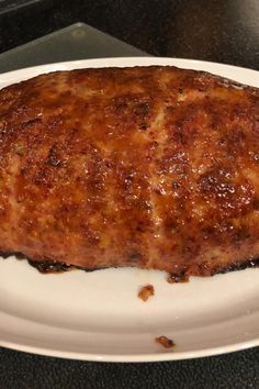 a piece of meat sitting on top of a white plate