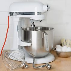 an electric mixer sitting on top of a wooden counter