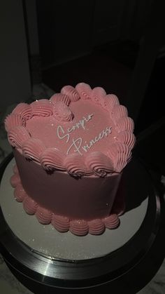 a pink heart shaped cake with the words happy anniversary written on it's side