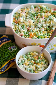 peas and corn are mixed together in a large casserole dish with a serving spoon