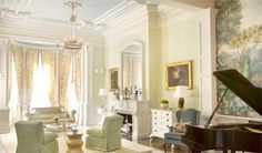 a living room filled with furniture and a grand piano