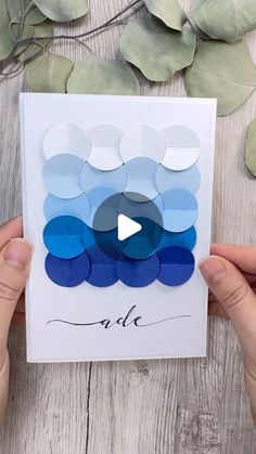 someone holding up a card with blue circles on it